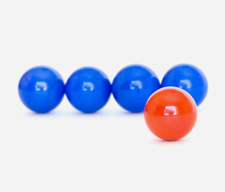 blue marbles in a row with red marble in front