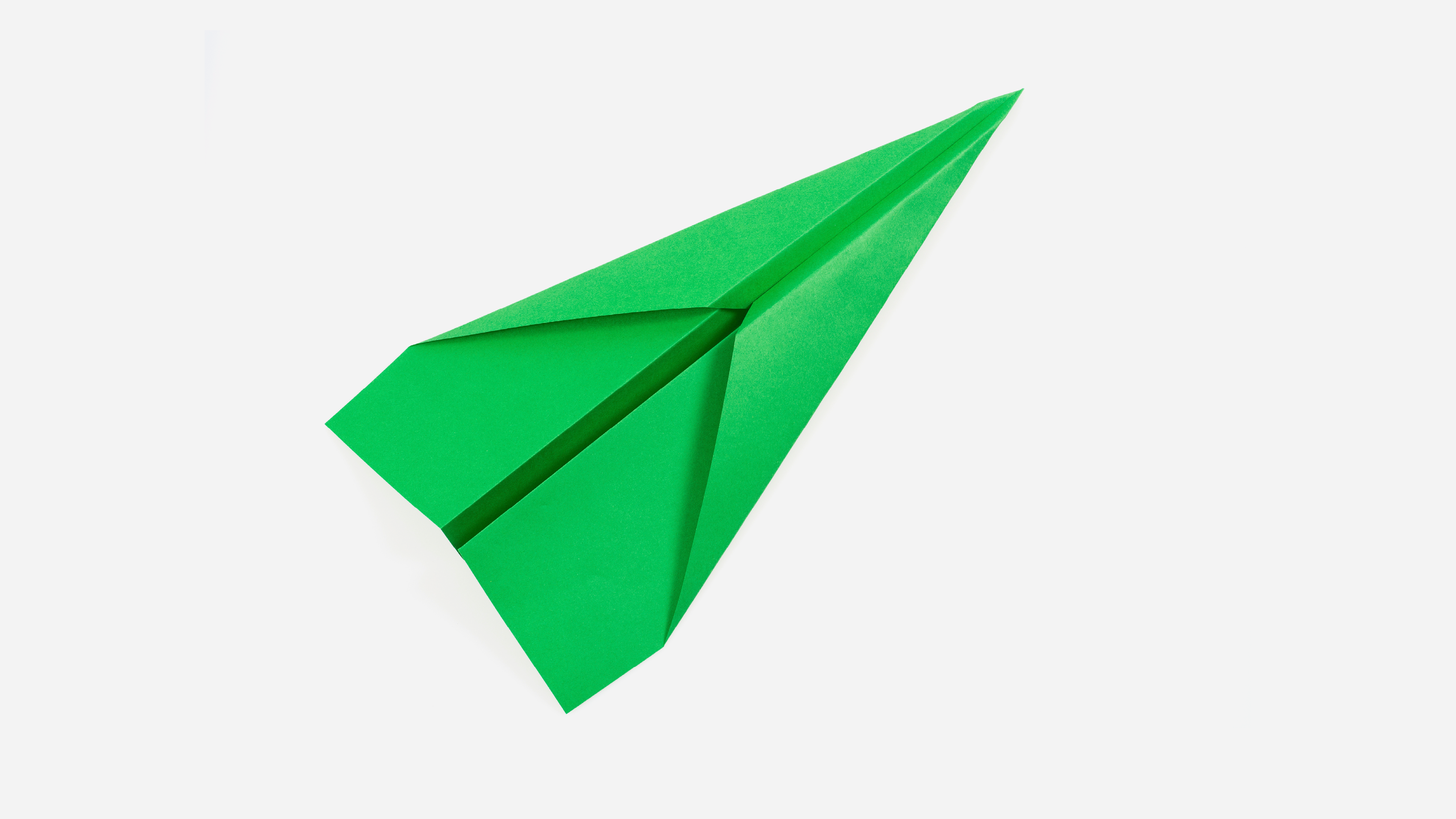 green paper airplane